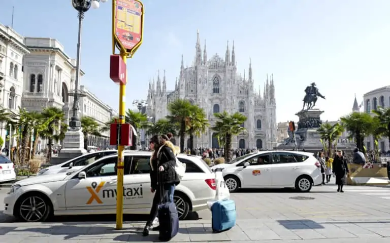white taxi station at Duomo square, in Milan.
